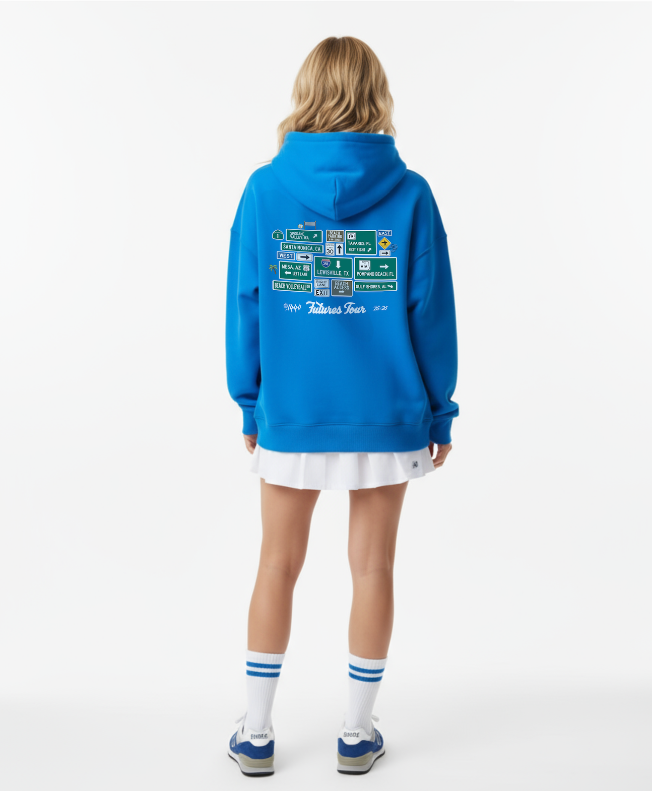 Person wearing a blue hoodie with text on the back, standing against a white background